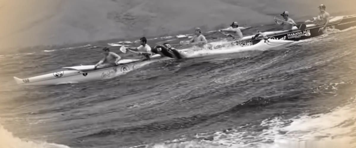 A full crew paddling in unison